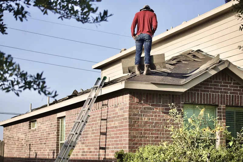 Professional roofer working on a residential roof in Newton Corner
